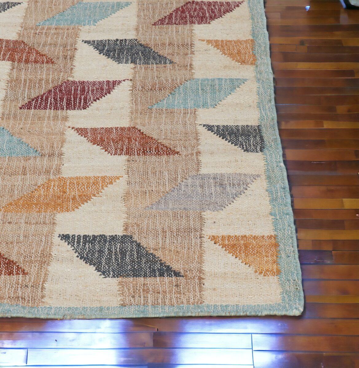 Multicolour triangle pattern rug on a wooden floor