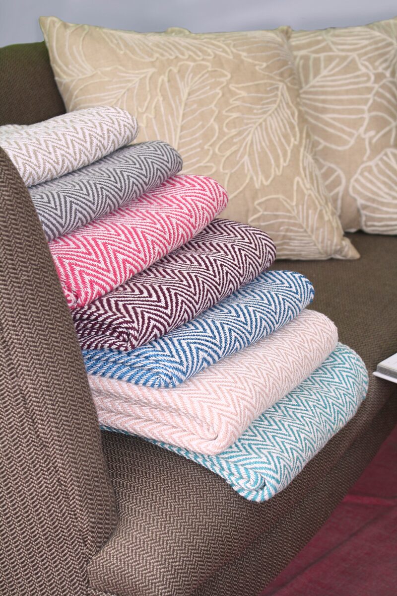 Stack of folded pastel throws