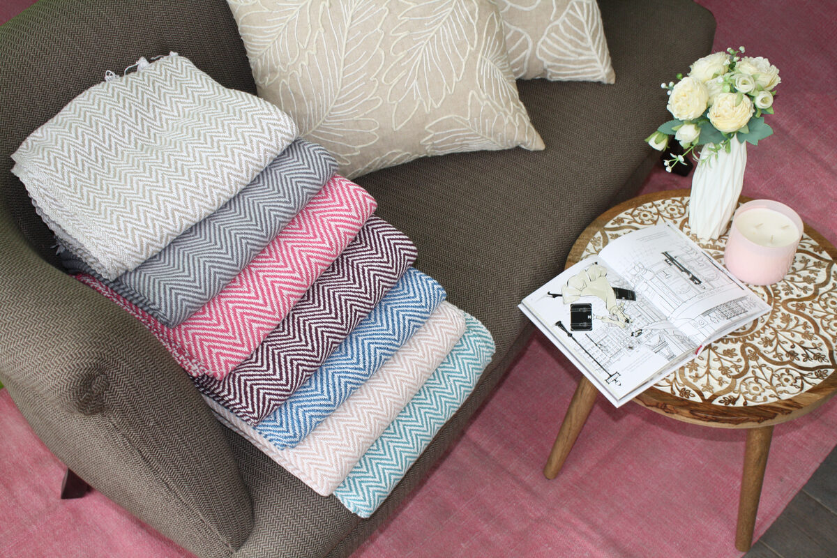 Folded throws on a table with flowers