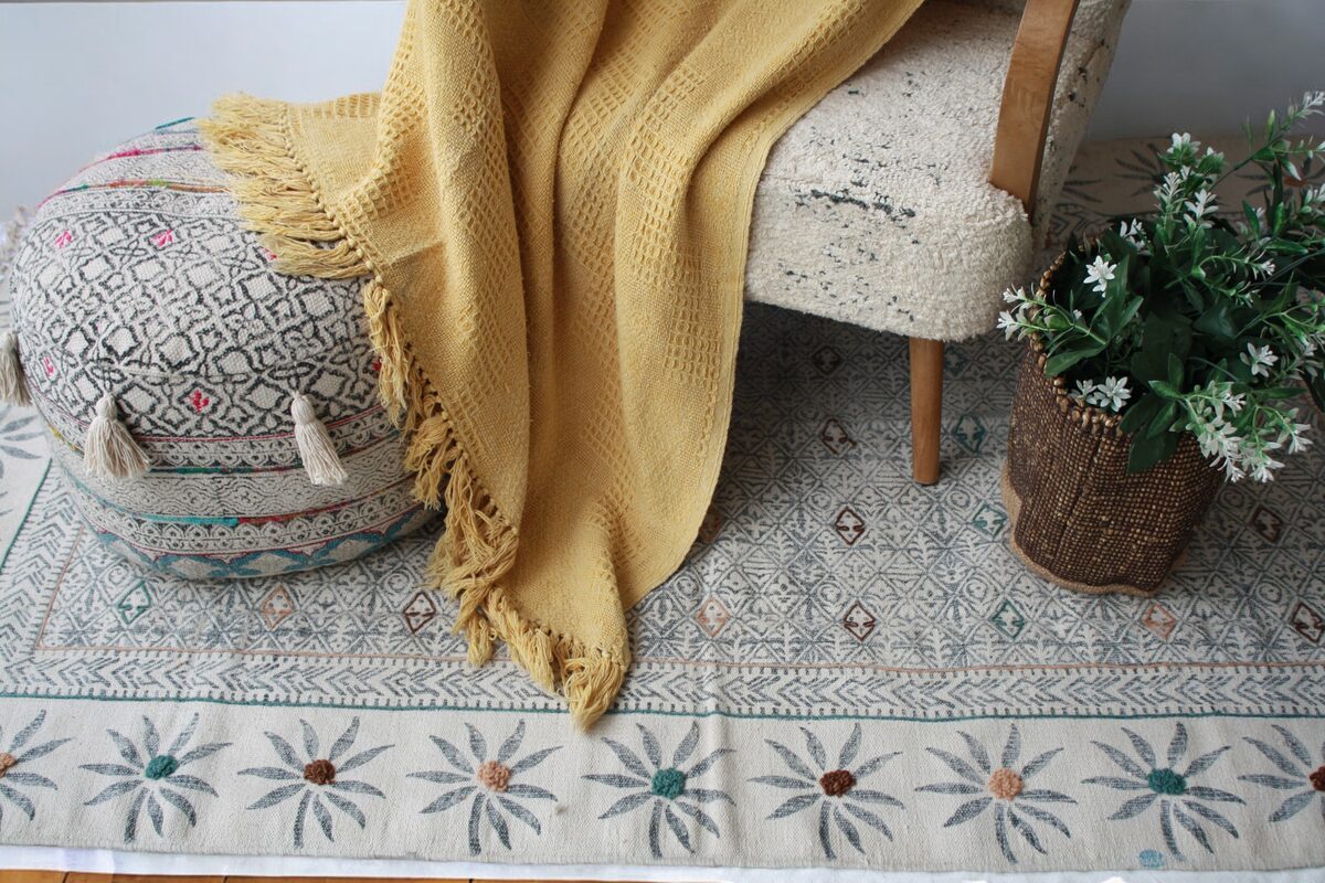 Mustard throw on a daybed with a pouf