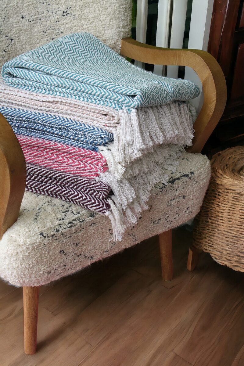 Pastel throws stacked on an armchair